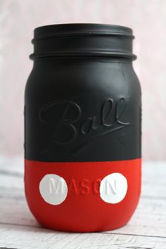 a black and red mason jar with the word ball on it