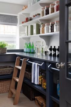 the shelves in this kitchen are filled with bottles and other things to put on them