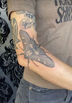 a man with a butterfly tattoo on his arm