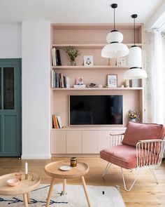 a living room filled with furniture and a flat screen tv mounted on a wall above a wooden coffee table