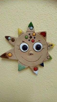 a close up of a wall with a sun decoration on it's face and eyes