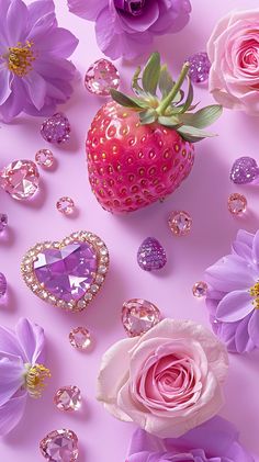 pink flowers and jewels surrounding a strawberry on a pink background