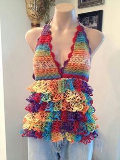 a mannequin wearing a multicolored crocheted halter top with ruffles