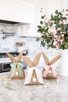 three easter bunnies sitting on top of a kitchen counter