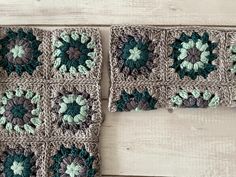 two crocheted squares with green and brown flowers on them sitting next to each other