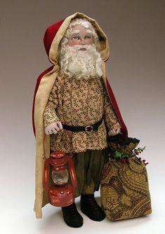 a figurine of santa claus holding a sack and lantern on a white background