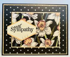 a card with flowers on it and the words sympathy written in black, white and gold