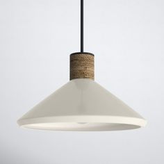 a white light hanging from a ceiling fixture with a rope wrapped around the bottom of it