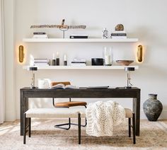 a room with a desk, chair and bookshelf filled with various items on top of it