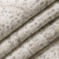 three pieces of fabric with different patterns and colors on the same cloth, one is beige