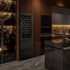 a modern kitchen with marble counter tops and black cabinets, along with an island in the middle