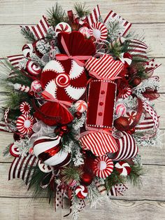 a wreath with red and white ornaments on it