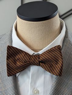 Elevate your style with this exquisite Brown Stripe Bow Tie. Handcrafted with precision and attention to detail, this custom self-tie bow tie is the perfect accessory to add a touch of sophistication to your outfit. Featuring a classic stripe pattern, this bow tie is versatile and can be paired effortlessly with both casual and conservative attire. Whether you're attending a business meeting or a social event, this bow tie will instantly elevate your look and make a lasting impression. Made from high-quality materials, this Brown Stripe Bow Tie is not only stylish but also durable, ensuring that it will last for years to come. The self-tie design allows for the perfect fit and gives you the freedom to adjust it according to your preference. With its timeless appeal, this bow tie is a must- Luxury Classic Bow Tie, Luxury Satin Bow Tie For Semi-formal Occasions, Classic Striped Ties For Black Tie Events, Classic Striped Tie For Black Tie Events, Classic Striped Tie For Black Tie Occasions, Classic Pre-tied Tie With Decorative Bow, Classic Pre-tied Bow Tie, Classic Pre-tied Bow With Ties, Elegant Striped Suit And Tie Accessories For Black Tie