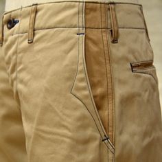 a close up of a person wearing khaki pants