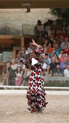 a woman in a red and white dress is throwing a frisbee at an audience