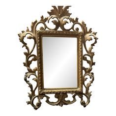 an ornate gold framed mirror against a white background