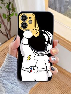 a person holding up a phone case with an astronaut on it