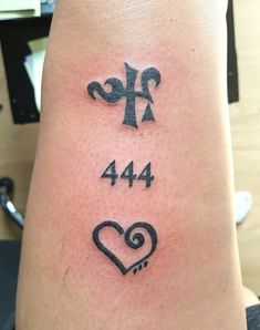 a tattoo with the number forty four on it's arm and an arrow in the shape of a heart