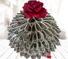 a flower made out of money sitting on top of a table