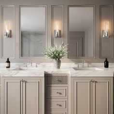 a bathroom with two sinks, mirrors and lights on the wall next to each other