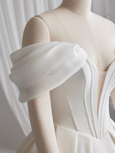 the back of a white wedding dress on a mannequin's headdress