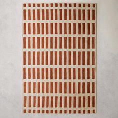 an orange and white square pattern on a gray wall with no one in the photo