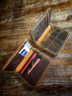 Slim 5 pocket minimalist bifold wallet can fit 2 or 3 cards comfortably per slot, and some folded cash. *Pictured in Autumn Harvest Leather with olive green thread, and Old Town Folklore Leather with black thread. *Autumn Harvest has a red/orange like pullup color. Wheat Harvest has a caramel like pullup color. Features: - 100% handcrafted - Saddle Stitched - Full grain leather from the U.S.A. - Wax Burnished edges Specs: *The wallet measures 4 3/16"H x 3 1/2"W x 1/2"D (closed). A single layer o Law Enforcement Equipment, Wheat Harvest, Green Thread, Handmade Leather Wallet, Autumn Harvest, Military Equipment, Black Thread, Slim Wallet, Bifold Wallet