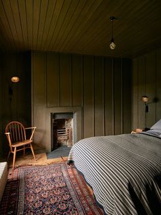 a bed sitting next to a fireplace in a bedroom