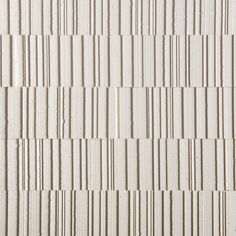 a white brick wall with vertical lines painted on it