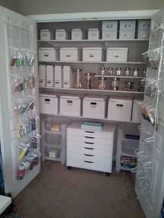 an organized pantry with white bins and clear shelves