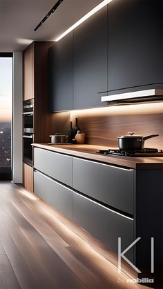 a modern kitchen with wood flooring and black cabinets, overlooking the city at night