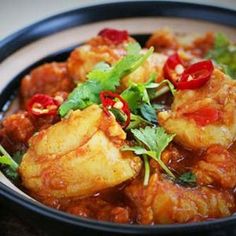 a black bowl filled with food on top of a table