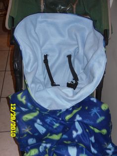 a baby stroller with the seat up and its cover over it's back