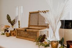 the table is decorated with wicker baskets, candles, and other decorative items on it