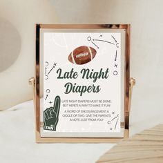 a sign that says late night diapers with a hand holding a football on it