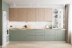 a kitchen with green cabinets and wooden floors, white walls and flooring is shown