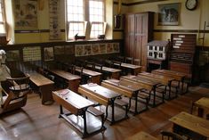 an old school room with many wooden desks