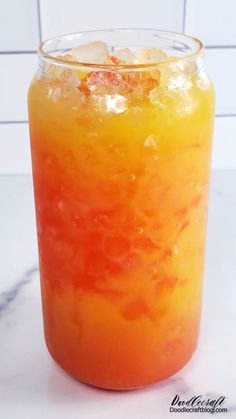 an orange and yellow drink sitting on top of a counter