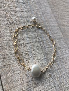 "14 kt gold fill chain and clasp with fresh water pearls. Great for layering with other bracelets or watch. Custom made in 6\" to 8.5\" sizes" Everyday Gold Single Strand Pearl Bracelet, Handmade Dainty Gold Pearl Bracelet, Dainty Handmade Gold Pearl Bracelet, Minimalist Baroque Pearl Bracelet, Elegant Handmade 14k Gold-filled Pearl Bracelet, Elegant Handmade 14k Gold Filled Pearl Bracelet, Gold Pearl Bracelet With 14k Gold Filled Pearl Chain, Gold 14k Gold Filled Pearl Chain Bracelet, Gold Pearl Chain Bracelet In 14k Gold Filled