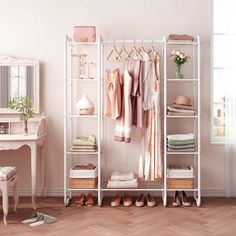 a white closet with clothes and shoes on shelves next to a desk, mirror and chair