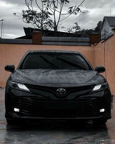 a black car parked in front of a building