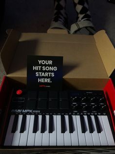 a box that has some kind of electronic keyboard in it with a sign reading your hit song starts here