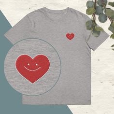 Discover the heart embroidered t-shirt, a perfect basic with a touch of originality. This is a short sleeve, round neck t-shirt made from heavyweight organic cotton. Its soft fabric and slightly fitted cut make it a very comfortable t-shirt that is suitable for both men and women. It is embroidered with a smiling heart design embroidered on the left chest. The embroidery is made up of red and white threads. Unisex t-shirt available in navy blue and black. One of the advantages of embroidery is t Relaxed Fit Cotton T-shirt As Gift, Casual T-shirt With Embroidered Text As Gift, Casual Embroidered Text T-shirt As Gift, Casual T-shirt With Embroidered Text For Gift, Cotton Graphic Tee With Heart Patch, Heart Graphic Short Sleeve T-shirt For Everyday, Casual Embroidered Graphic T-shirt As Gift, Cotton Relaxed Fit T-shirt As Gift, Cotton Relaxed Fit T-shirt For Gift