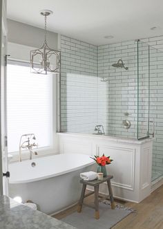 a white bath tub sitting next to a window