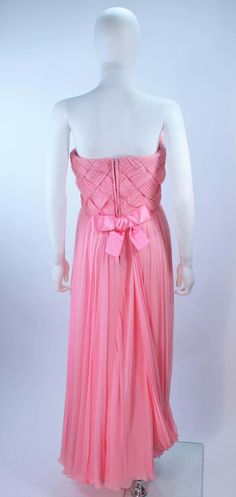 For Sale on 1stDibs - This Scaasi gown is composed of a pink chiffon. The bodice has a criss-cross design. The skirt features a drape style. There is a center back zipper closure Pink Silk Pre-draped Maxi Dress, Pink Pleated Bodice Gown For Evening, Pink Sleeveless Gown With Sheer Bodice, Pink Sleeveless Chiffon Wedding Dress, Pink Sleeveless Chiffon Dress For Wedding, Pink Gown With Pleated Bodice And Sweetheart Neckline, Pre-draped Pink Silk Evening Dress, Pink Floor-length Gown With Lined Bodice, Pink Silk Gown With Pleated Bodice