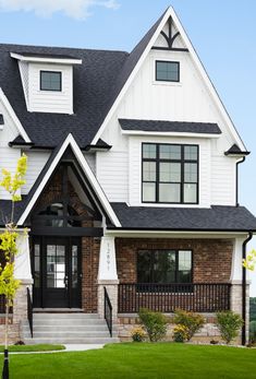 a large white house with black trim and windows