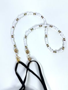 Marshmallow Child Lanyard: Small marshmallow white acrylic beads accented with gold lined glass seed beads and gold metal accents. A sweet incentive to encourage ID, glasses, or mask wear and care and give your child a bit of personality while wearing them. This simple 17 inch child size lanyard keeps hands free and the items off the floor. Mask hooks with simple easy clasps to mask earpieces for use and rests on chest between uses. When you order, let me know if you need eyeglasses or badge holder so I can include them with your lanyard. > Please be aware NOT to use this lanyard if there is a concern for strangling< > Use a flexible measuring tape to make sure the 17 inch length plus mask will be the correct size for your child. Correct size with mask attached, should fit easily overhead Mask Holder, Mask Chain, Glasses Holder, Eye Glass, Gold Line, Metal Accents, Measuring Tape, Glass Seed Beads, White Acrylics