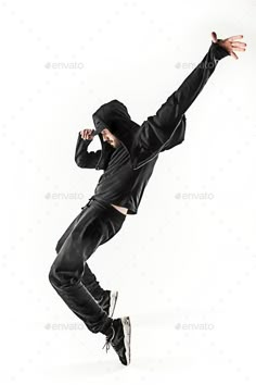 a man in black clothes jumping up into the air