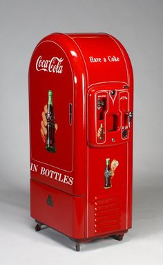 an old coca - cola machine is on display in a studio photo against a gray background