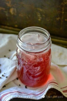 a jar filled with liquid sitting on top of a table